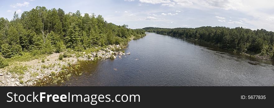 Panoramic view of a river surrounded by forests. Panoramic view of a river surrounded by forests