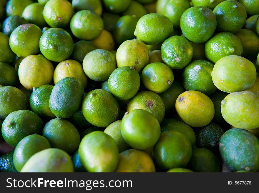 An image of fresh vibrant limes at an outdoor market