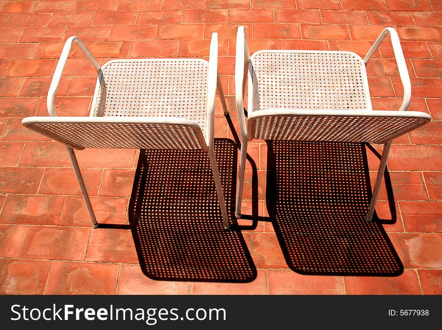 Two chairs for a sunbath on the terrace, nice shadows. Two chairs for a sunbath on the terrace, nice shadows