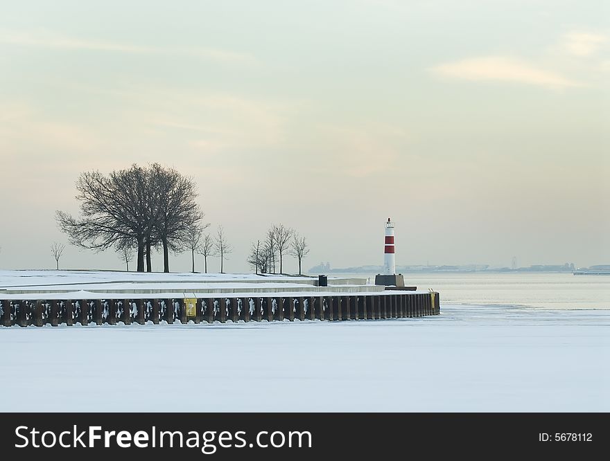 Lighthouse surrounded by trees. Winter time. Lighthouse surrounded by trees. Winter time.