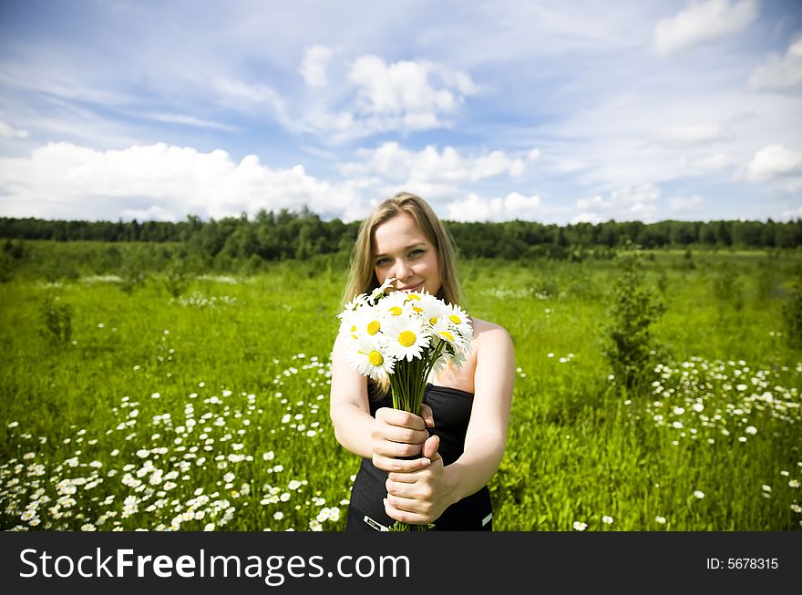 Woman With Flowers On The Meadow