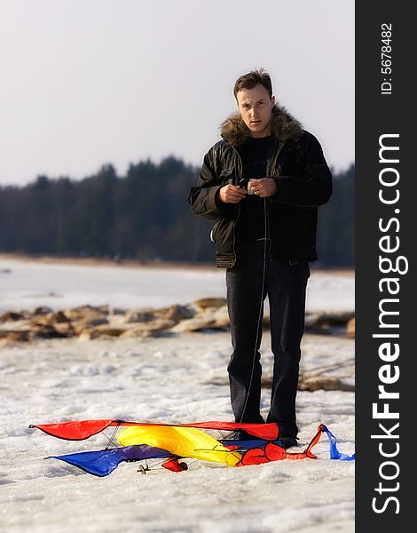 The man and a kite. Winter. Russia.