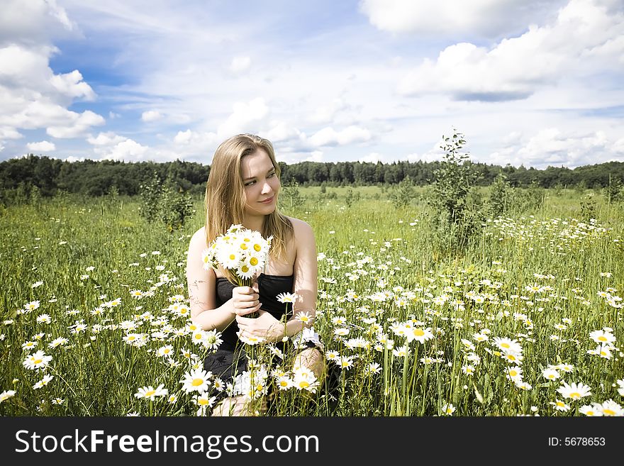 Young Woman With Flowers Relaxing Outdoors. Young Woman With Flowers Relaxing Outdoors