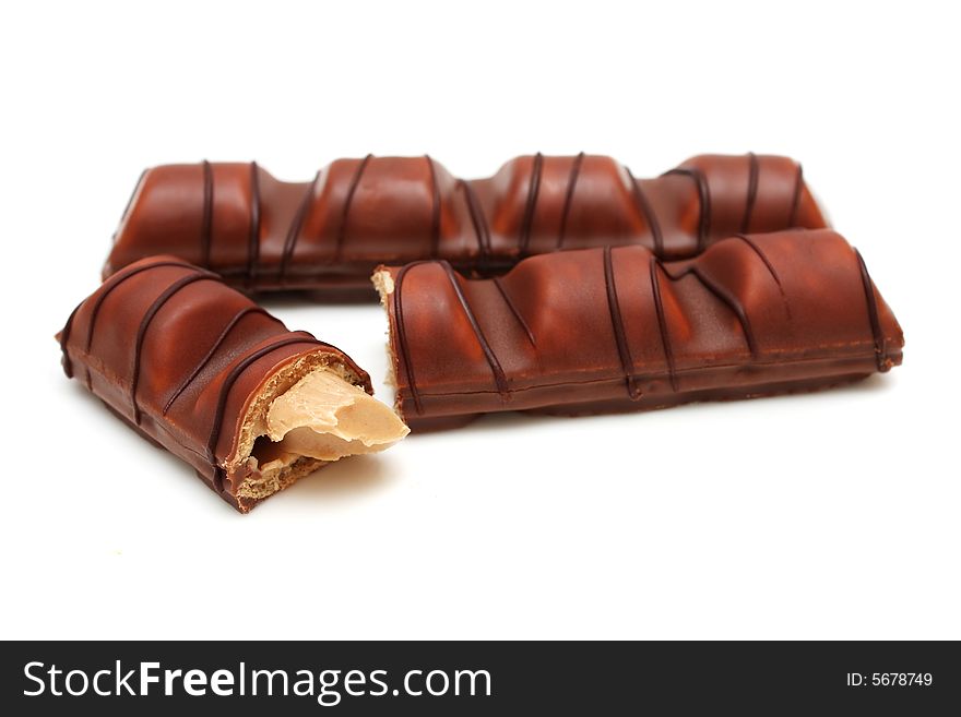 Milk chocolate bars covered wafer on white background.