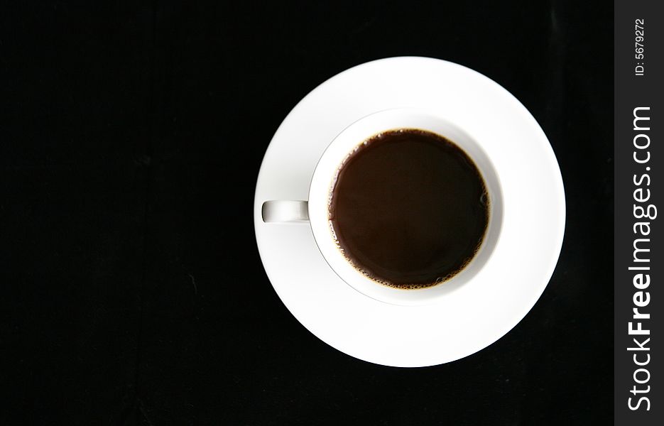 Top view of a cup of coffee on a saucer.