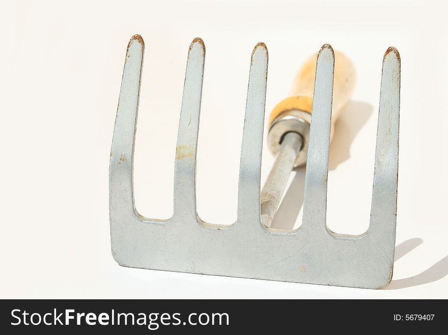 Hand rake against white background