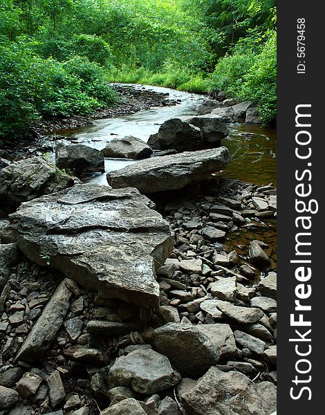 Several pieces of rock on a river bed in a park. Several pieces of rock on a river bed in a park