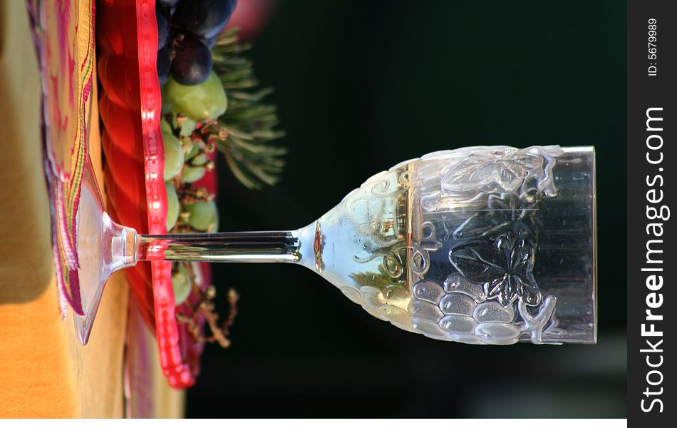 Wine glass with plate of fruit in the backround. Wine glass with plate of fruit in the backround.