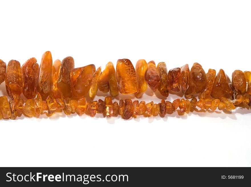 Thread of amber bead on white background. close-up. Thread of amber bead on white background. close-up.