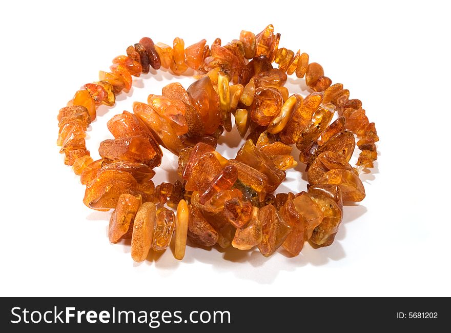 Thread of amber bead on white background. close-up. Thread of amber bead on white background. close-up.