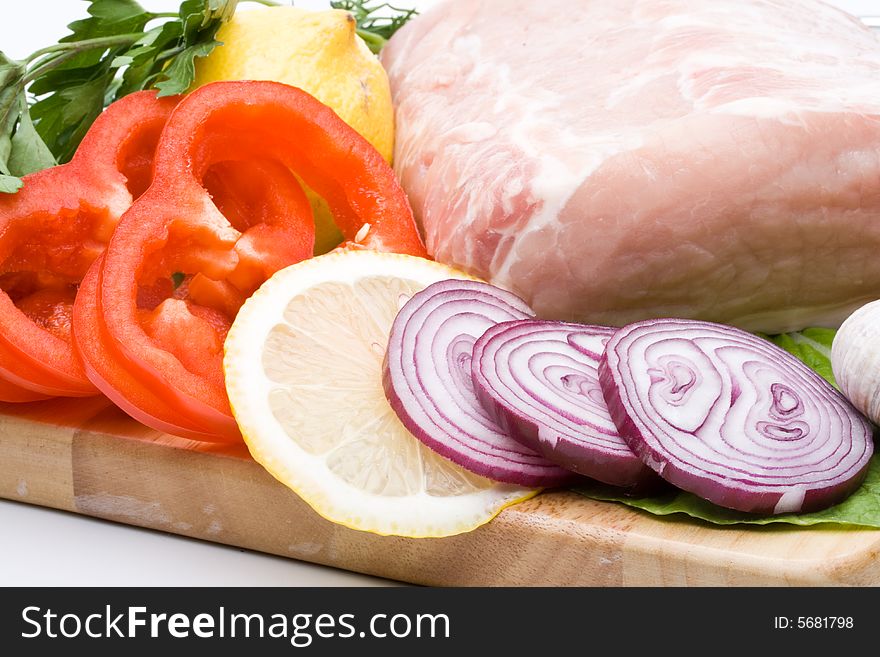 Fresh meat with vegetables on a white background. Close up.