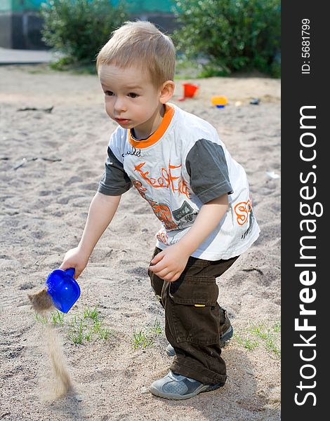 Boy playing in sand-box