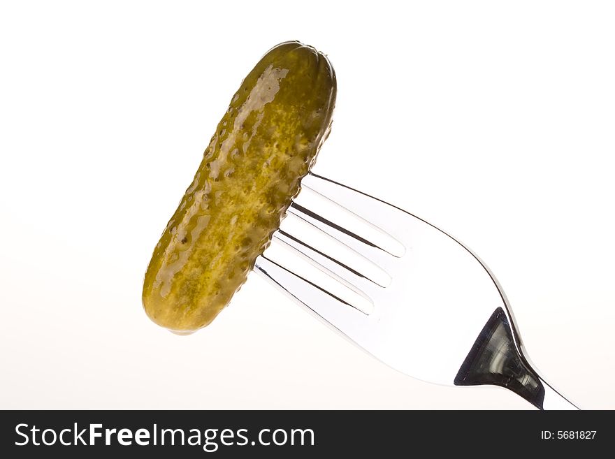 Crackling pickled gherkins on a plug on a white background