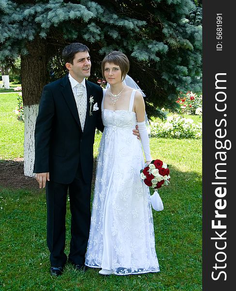 Young couple married on a green meadow