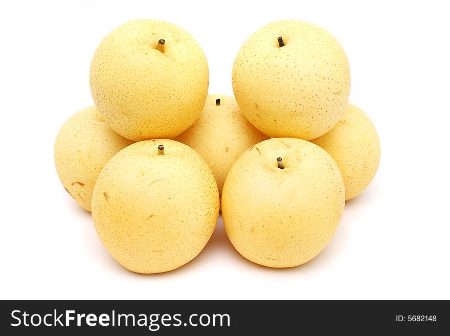 Nashi pears stacked on white background.