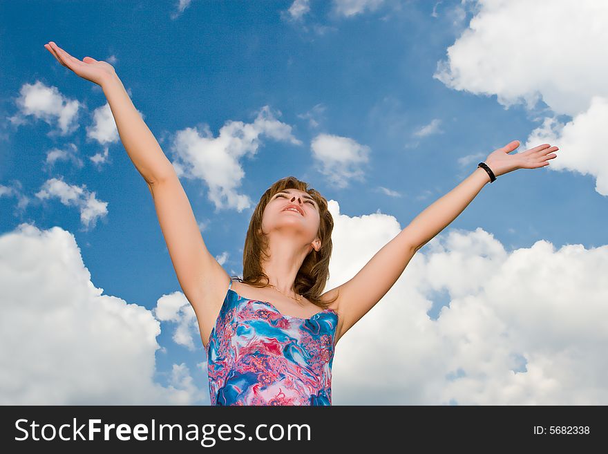 Portrait of the beautiful girl on a background of the blue sky with clouds. Portrait of the beautiful girl on a background of the blue sky with clouds