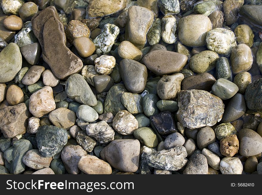 Many sort of colorful pebbles by seaside. Many sort of colorful pebbles by seaside