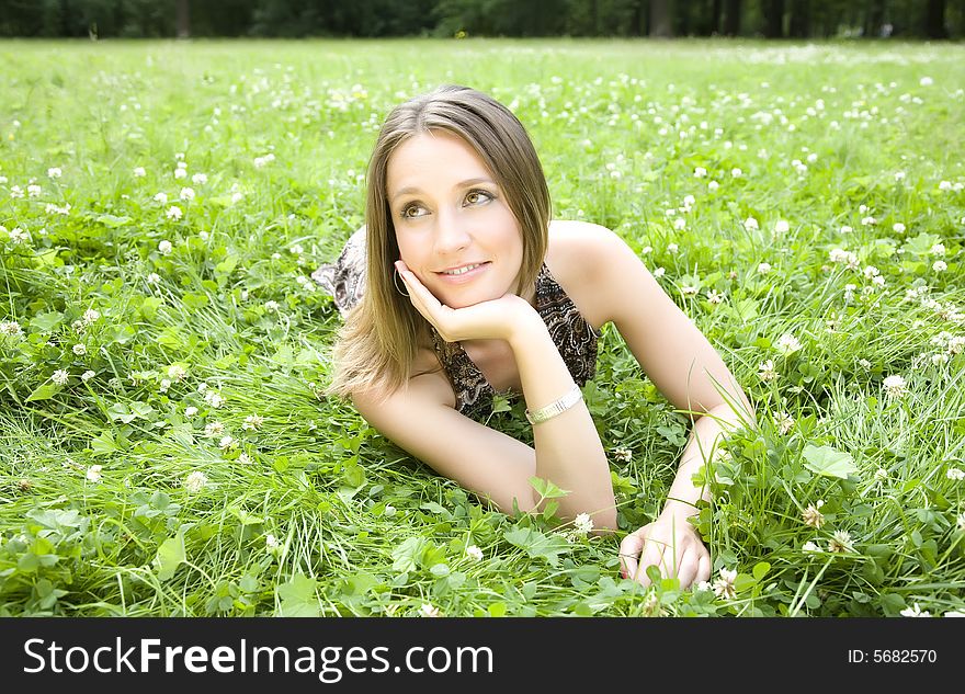 The Woman Laying On A Meadow