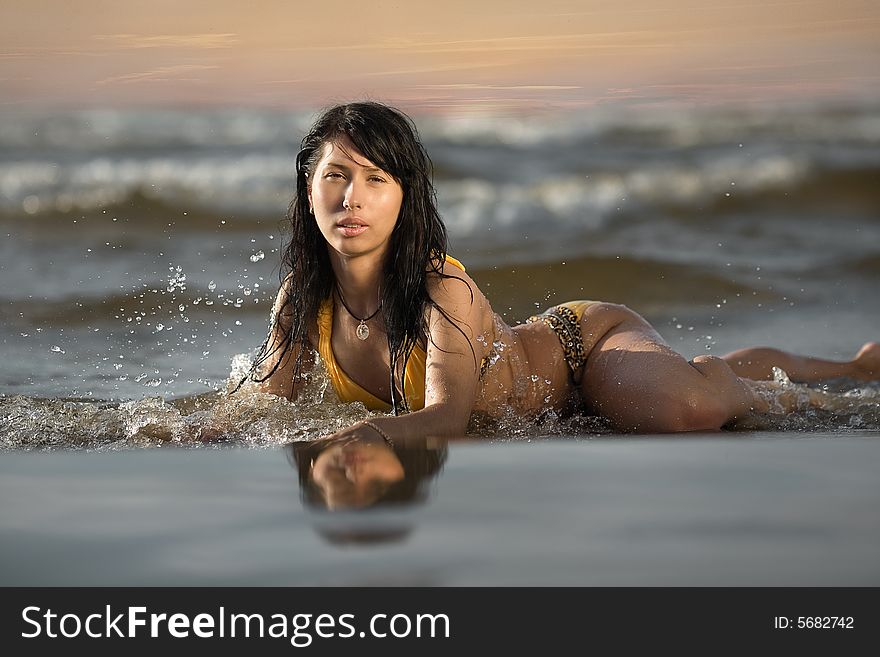A beautiful woman relaxing on the beach. A beautiful woman relaxing on the beach