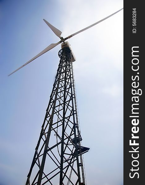 Wind turbine on sky background