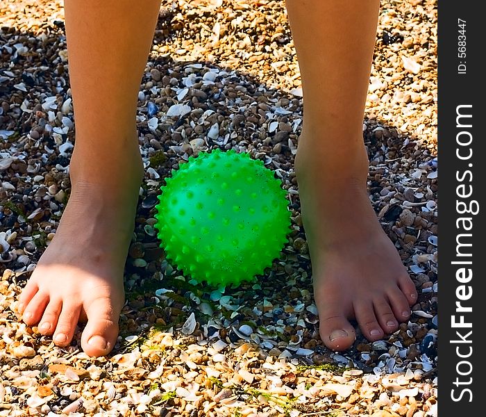 Child Feet On Sand At Green Ball