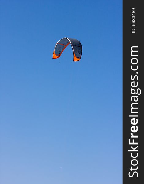 A surf kite against a blue sky. A surf kite against a blue sky