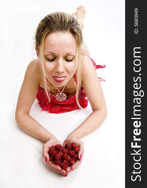 Long hair blonde woman in red with whole palms of raspberries. Long hair blonde woman in red with whole palms of raspberries