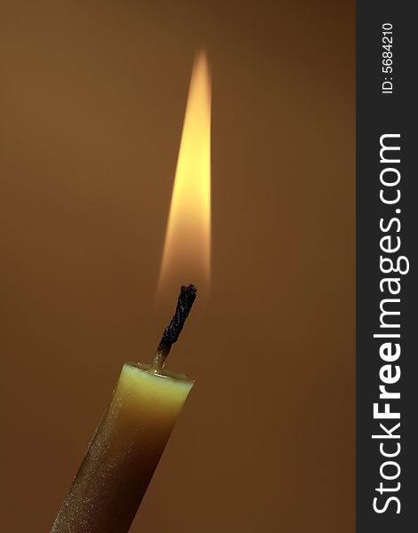 Photo of a burning candle on background. Photo of a burning candle on background