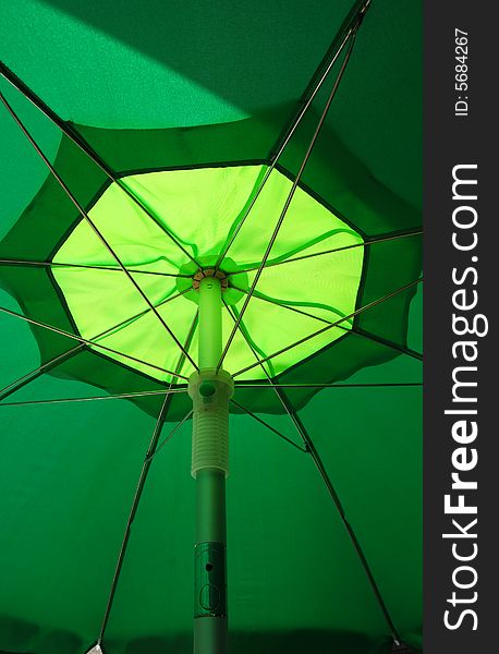 View of a green and yellow umbrella from the inside