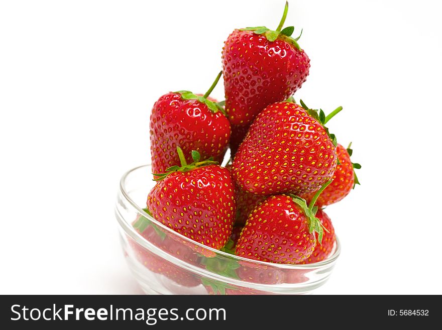 High key photo of fruit dish filled with nice red strawberries. High key photo of fruit dish filled with nice red strawberries