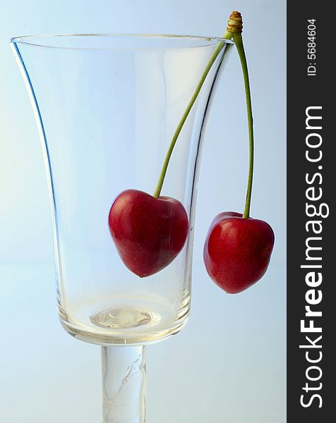 Ripe cherries in a glass on white background. Ripe cherries in a glass on white background