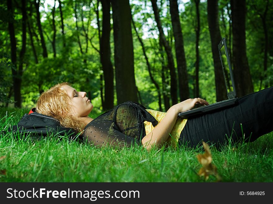 Student girl relaxing in the park. Student girl relaxing in the park.