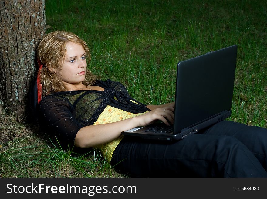 Student girl relaxing in the park. Student girl relaxing in the park.