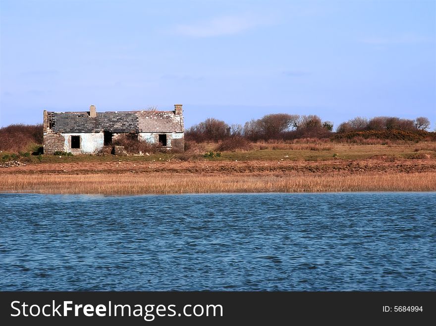 An isolated cottage in the irish country side beside a river. An isolated cottage in the irish country side beside a river