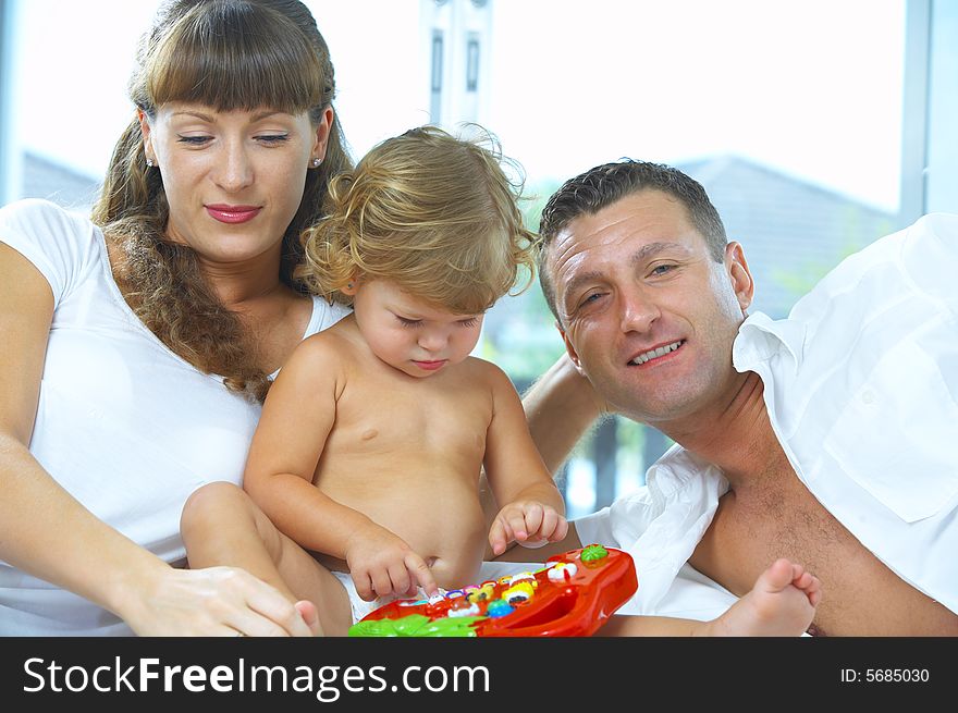 High key portrait of nice young family getting busy. High key portrait of nice young family getting busy