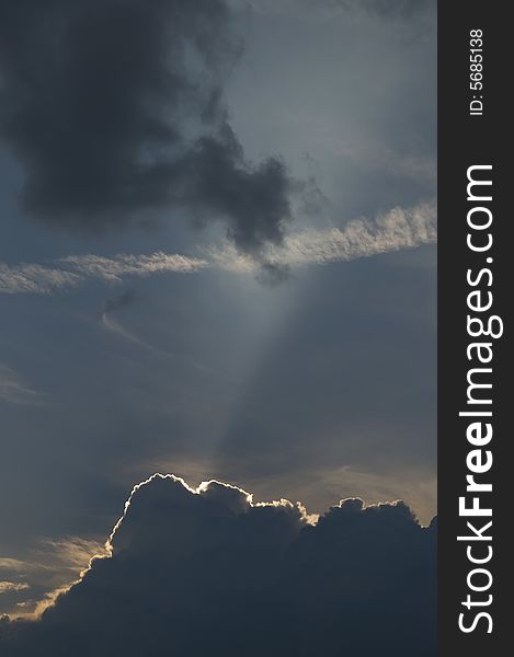 Picture of the sun blast over the beach at sunset about to be engulfed by storm clouds