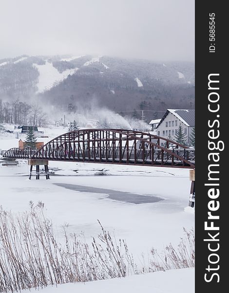 Bridge over frozen Lake in a very cold ski resort