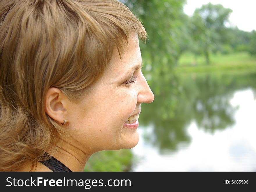 Attractive young woman on the green grass