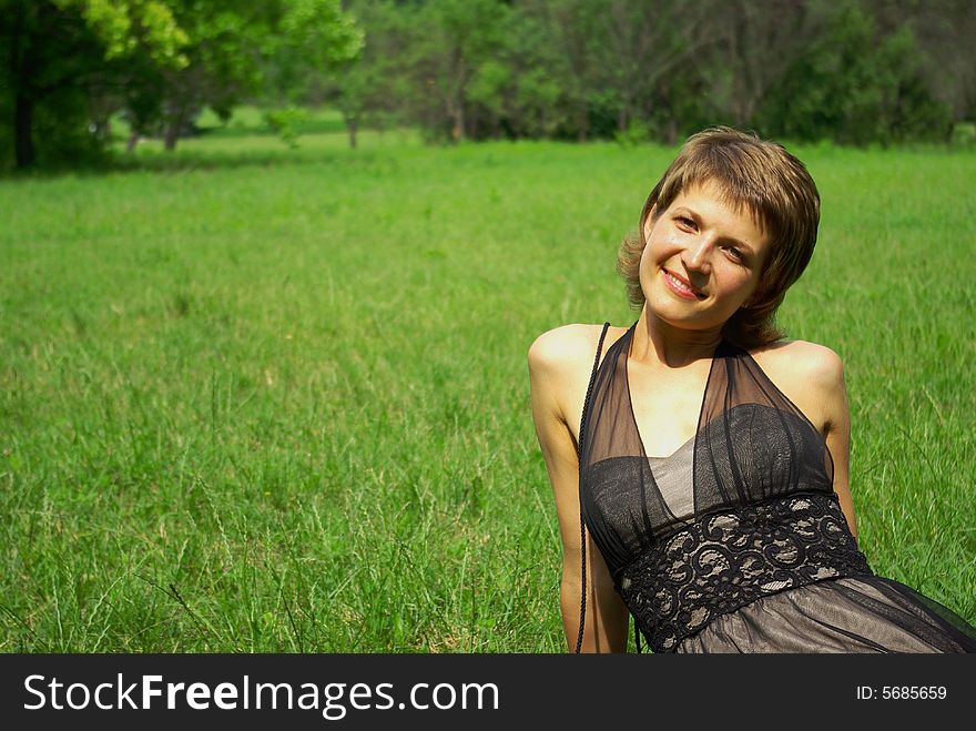 Attractive young woman on the green grass