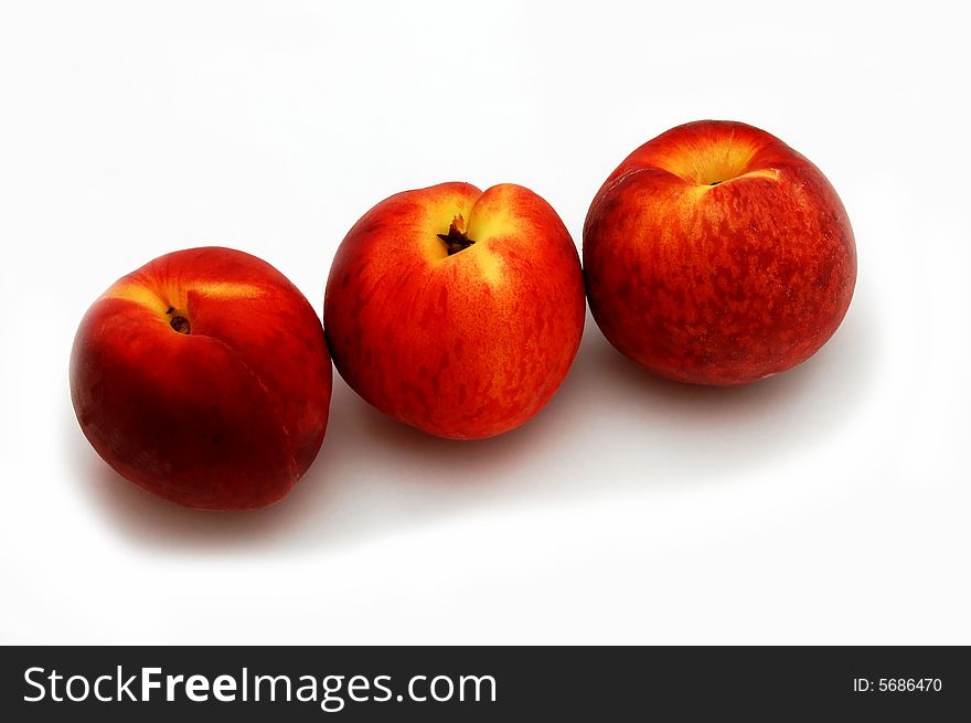 Three peaches isolated on the white background