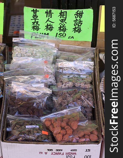 A shot of a market stall selling oriental plum candies in China Town. A shot of a market stall selling oriental plum candies in China Town.