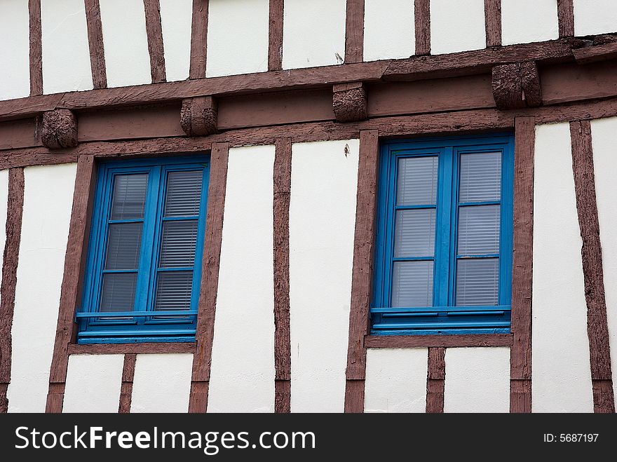 Facade of a typical antique house with deformed beams. Facade of a typical antique house with deformed beams