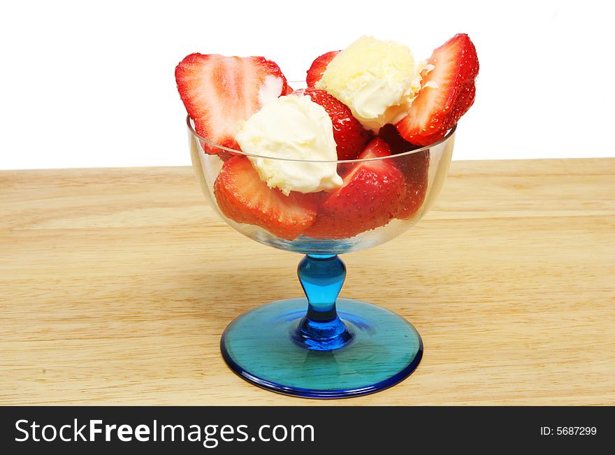 Strawberries and clotted cream in a sundae glass. Strawberries and clotted cream in a sundae glass