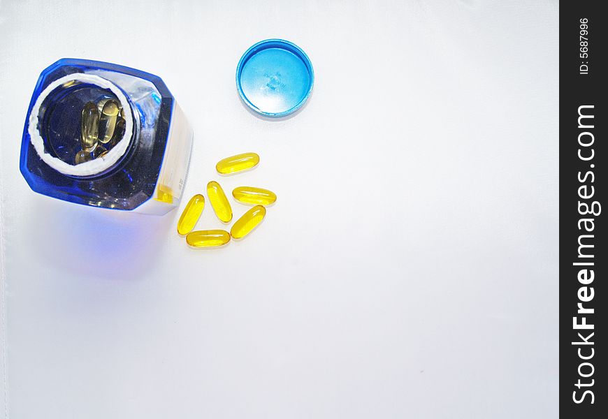 Vitamins  with vitamin bottle and lid on white background