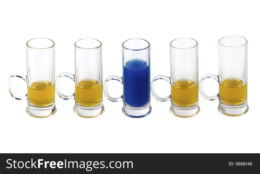 Shot glases with yellow and blue alcohol on white background. Shot glases with yellow and blue alcohol on white background