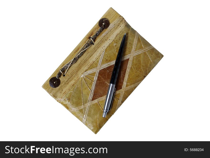 The pen and handmade bamboo notebook on white background