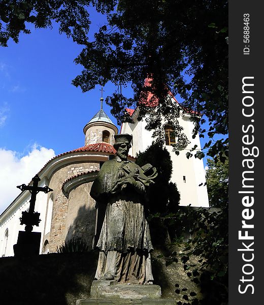 Statue of saint in front of old church (Czech rep.)