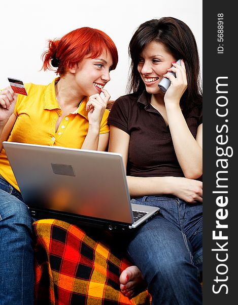 Two young women with laptop and phone. Two young women with laptop and phone