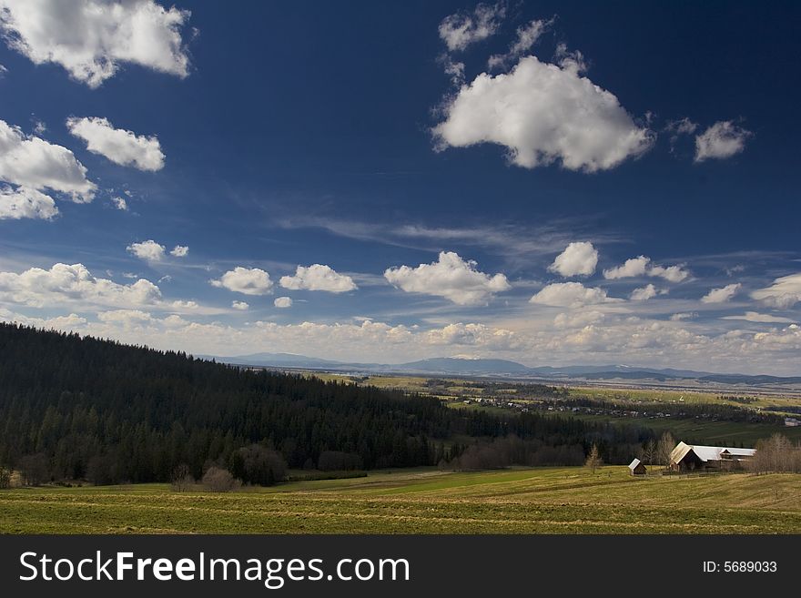 Forest, green meadow, blue sky and small house. Forest, green meadow, blue sky and small house