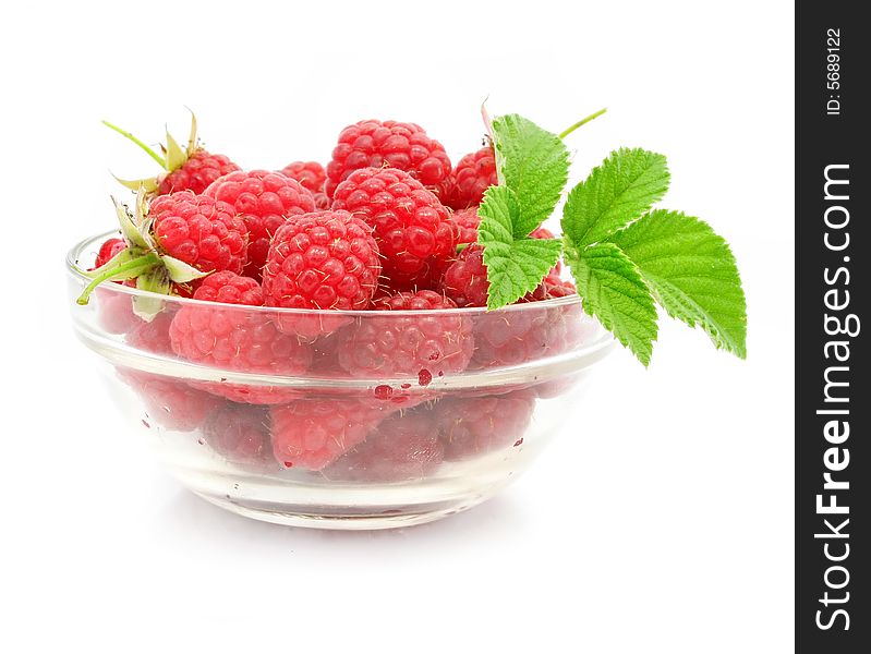 Red raspberry fruits in glass vase isolated on white background